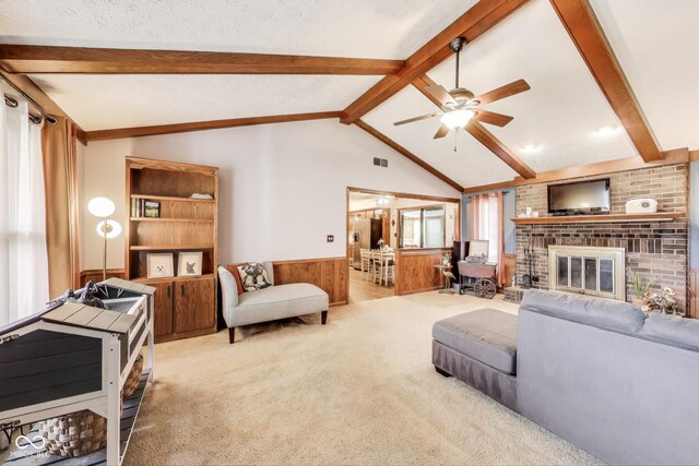 7152 Sandalwood Dr, Avon, IN 46123 - carpeted living room featuring a fireplace, lofted ceiling with beams, wainscoting, visible vents, and ceiling fan