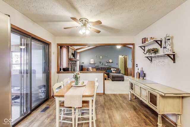 7152 Sandalwood Dr, Avon, IN 46123 - dining area with a textured ceiling, visible vents, a ceiling fan, and light wood finished floors
