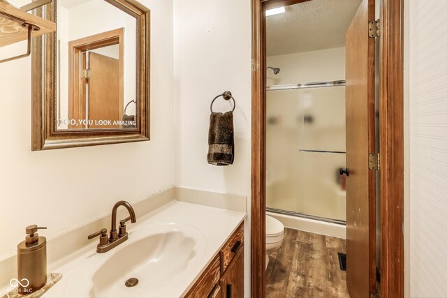 7152 Sandalwood Dr, Avon, IN 46123 - full bath featuring vanity, toilet, a textured ceiling, a stall shower, and wood finished floors