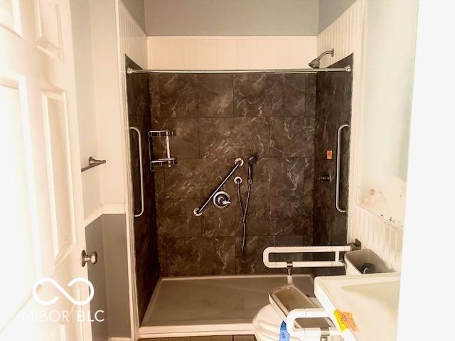 bathroom with a stall shower and toilet