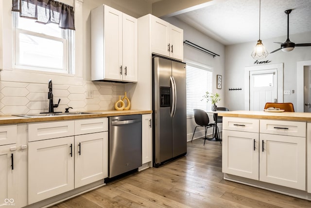 3732 N Kenwood Ave, Indianapolis, IN 46208 - kitchen with stainless steel appliances, butcher block countertops, tasteful backsplash, and white cabinets