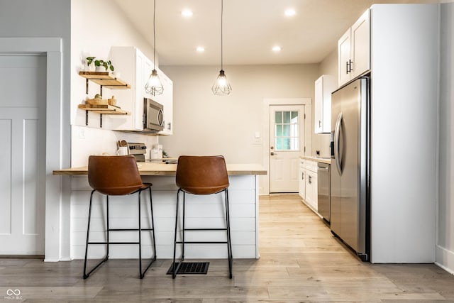 3732 N Kenwood Ave, Indianapolis, IN 46208 - kitchen with stainless steel appliances, open shelves, a kitchen bar, white cabinets, and recessed lighting