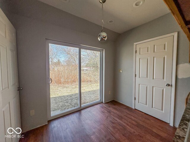 unfurnished dining area featuring dark wood-style floors