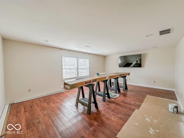 dining area with visible vents, baseboards, and wood finished floors