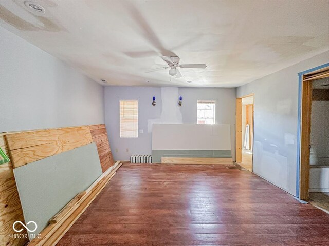 unfurnished room featuring wood finished floors and a ceiling fan