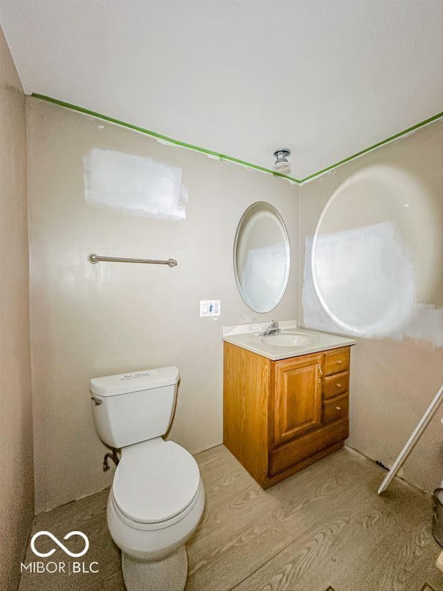 bathroom featuring toilet and vanity