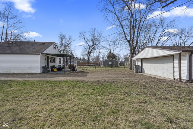 3104 Alice Ave, Indianapolis, IN 46237 - view of yard featuring an outbuilding, fence, and a detached garage