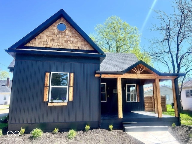 511 N Clark St, Lebanon, IN 46052 - view of front facade featuring board and batten siding, covered porch, and a shingled roof