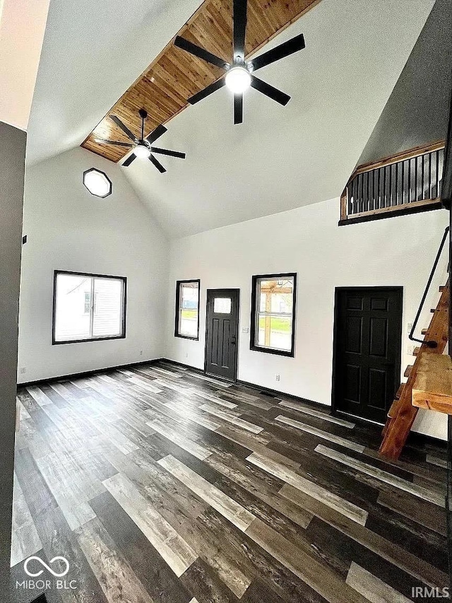 511 N Clark St, Lebanon, IN 46052 - unfurnished living room with baseboards, high vaulted ceiling, a ceiling fan, and wood finished floors