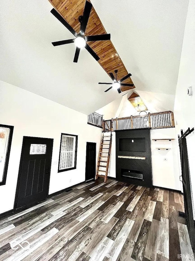 511 N Clark St, Lebanon, IN 46052 - unfurnished living room with wood finished floors, high vaulted ceiling, ceiling fan, and stairs