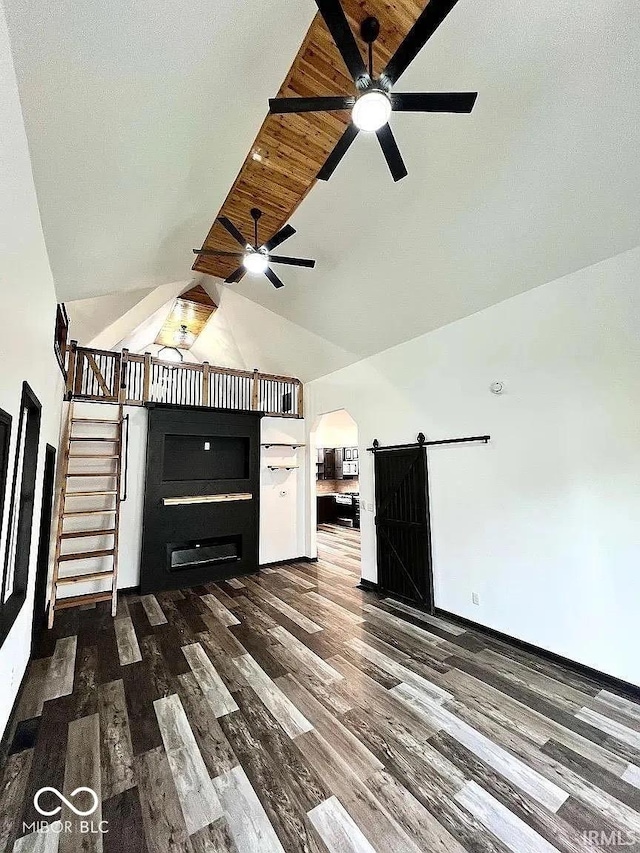 511 N Clark St, Lebanon, IN 46052 - unfurnished living room with ceiling fan, a barn door, wood finished floors, arched walkways, and high vaulted ceiling