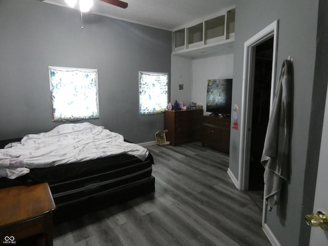 bedroom with wood finished floors, baseboards, and ceiling fan