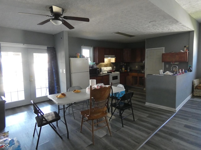 dining area featuring dark wood-style floors, french doors, baseboards, and a textured ceiling