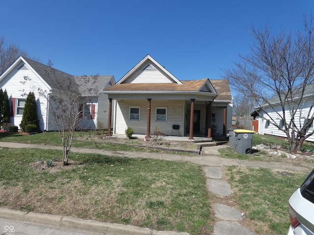 bungalow-style home with a porch and a front yard