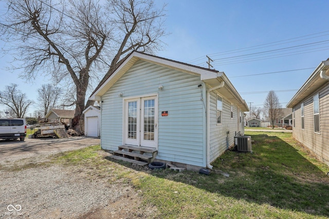 1039 S Ohio St, Martinsville, IN 46151 - exterior space with dirt driveway, entry steps, central AC, an outdoor structure, and a garage