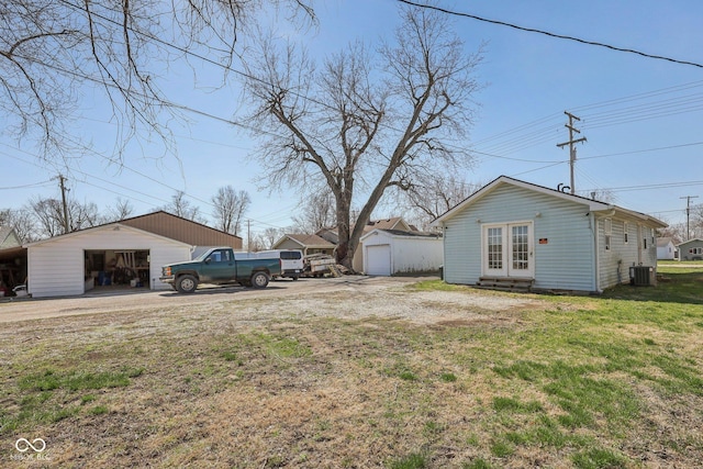 1039 S Ohio St, Martinsville, IN 46151 - view of yard featuring an outbuilding, french doors, a garage, and central AC