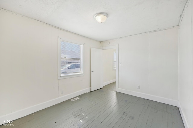 1039 S Ohio St, Martinsville, IN 46151 - spare room featuring visible vents, baseboards, and hardwood / wood-style flooring