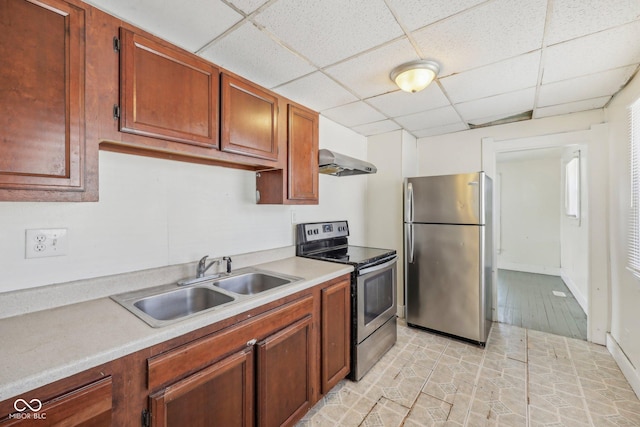 1039 S Ohio St, Martinsville, IN 46151 - kitchen with a drop ceiling, light countertops, appliances with stainless steel finishes, wall chimney exhaust hood, and a sink