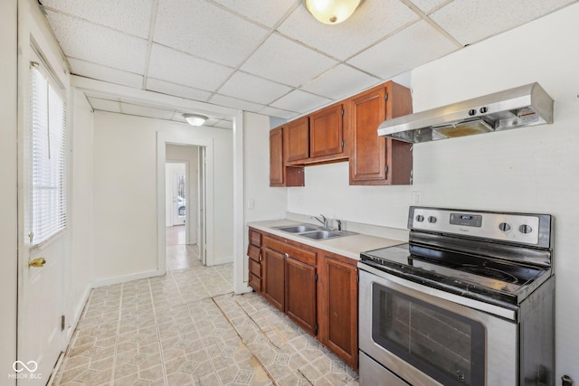 1039 S Ohio St, Martinsville, IN 46151 - kitchen with stainless steel electric range, a sink, light countertops, a paneled ceiling, and wall chimney range hood