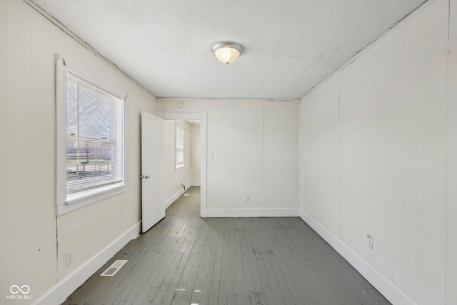 1039 S Ohio St, Martinsville, IN 46151 - empty room with hardwood / wood-style flooring, baseboards, visible vents, and a textured ceiling