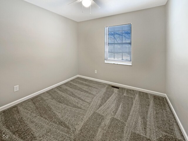 carpeted empty room featuring ceiling fan, baseboards, and visible vents