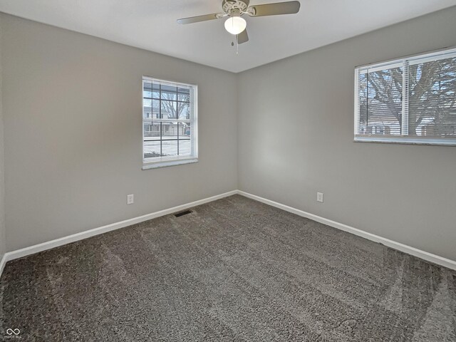 empty room featuring ceiling fan, baseboards, carpet flooring, and visible vents
