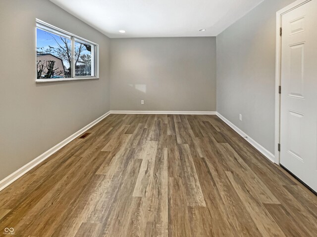 interior space with baseboards, wood finished floors, visible vents, and recessed lighting