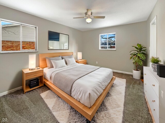 carpeted bedroom with baseboards and a ceiling fan