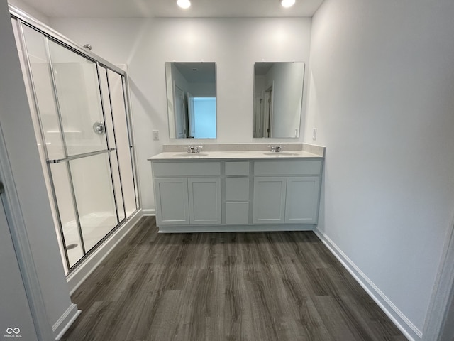 1265 Fleming Dr, Greenfield, IN 46140 - bathroom with wood finished floors, a shower stall, double vanity, and recessed lighting