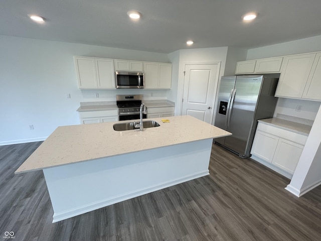 1265 Fleming Dr, Greenfield, IN 46140 - kitchen featuring stainless steel appliances, an island with sink, white cabinetry, dark wood finished floors, and recessed lighting