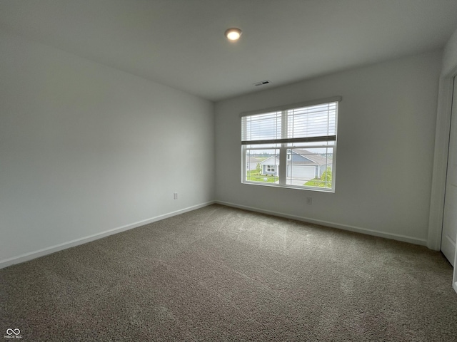 1265 Fleming Dr, Greenfield, IN 46140 - spare room featuring baseboards and carpet flooring