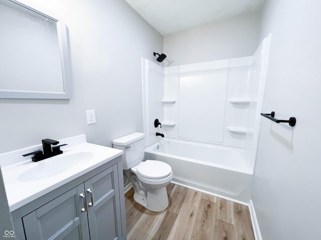 full bath featuring toilet, vanity, bathing tub / shower combination, and wood finished floors
