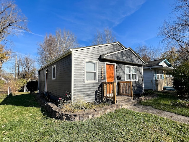 bungalow-style home with a front yard