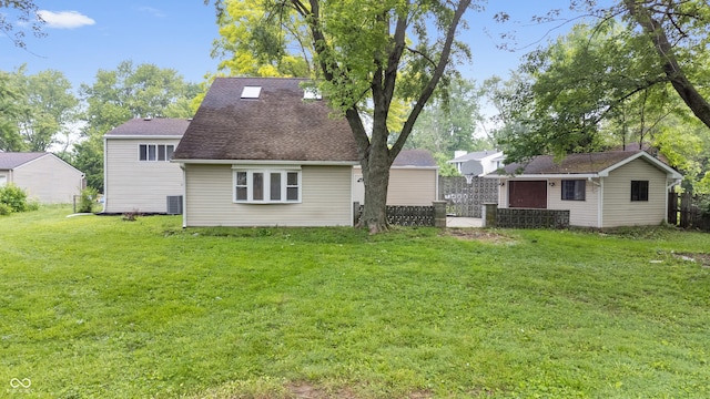 1641 Whistler Ter, Indianapolis, IN 46229 - back of property featuring a yard, an outbuilding, cooling unit, and a shingled roof