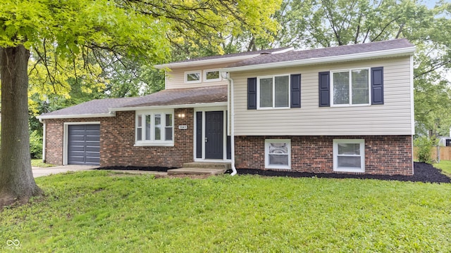1641 Whistler Ter, Indianapolis, IN 46229 - tri-level home featuring an attached garage, a front yard, brick siding, driveway, and entry steps