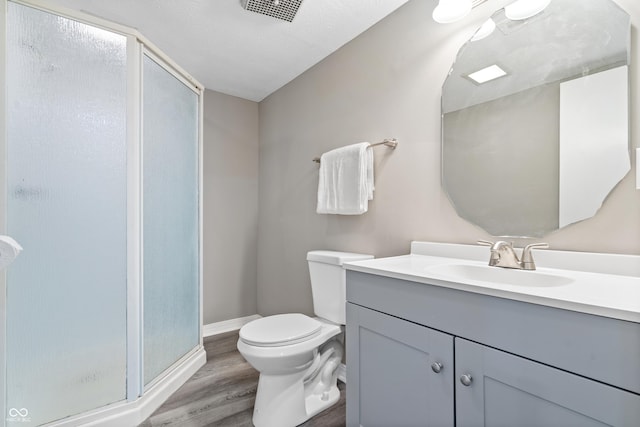 1641 Whistler Ter, Indianapolis, IN 46229 - bathroom featuring vanity, wood finished floors, a stall shower, toilet, and baseboards