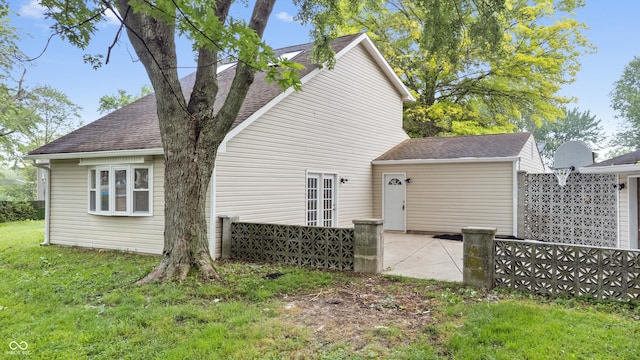 1641 Whistler Ter, Indianapolis, IN 46229 - rear view of property featuring a shingled roof, a patio, and a yard