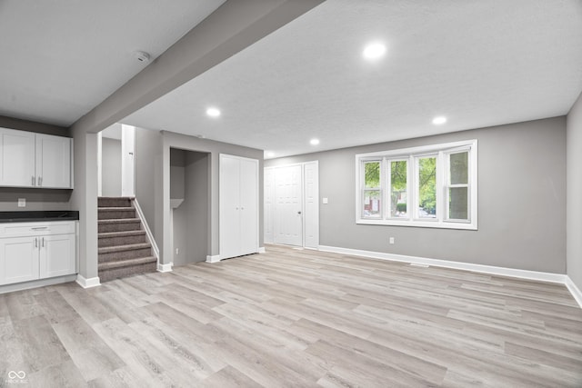 1641 Whistler Ter, Indianapolis, IN 46229 - unfurnished living room with recessed lighting, light wood-type flooring, stairway, and baseboards