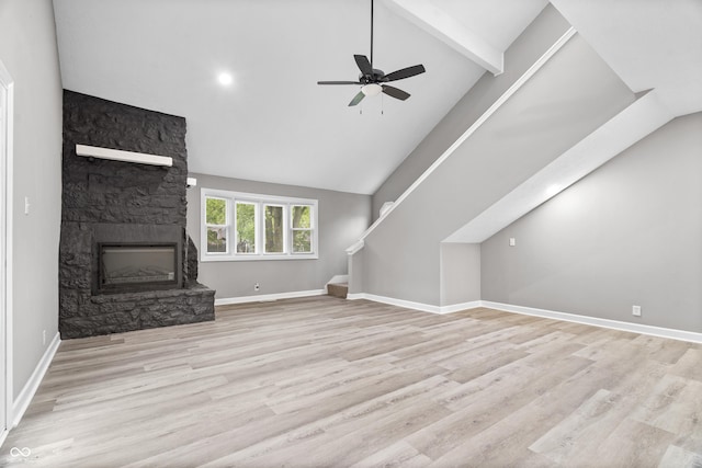 1641 Whistler Ter, Indianapolis, IN 46229 - unfurnished living room with a stone fireplace, a ceiling fan, wood finished floors, beamed ceiling, and high vaulted ceiling