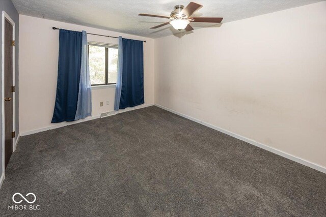7965 Benjamin Dr, Lawrence, IN 46226 - empty room featuring ceiling fan, dark carpet, and a textured ceiling