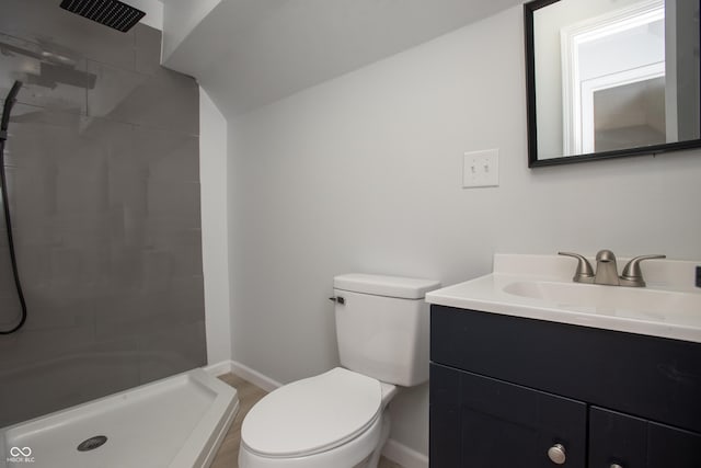 249 N Hamilton Ave, Indianapolis, IN 46201 - bathroom with toilet, baseboards, tiled shower, and vanity