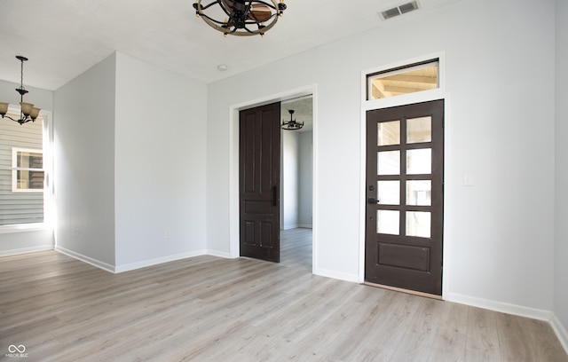 249 N Hamilton Ave, Indianapolis, IN 46201 - entrance foyer featuring visible vents, light wood-style floors, baseboards, and a chandelier