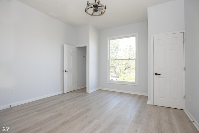 249 N Hamilton Ave, Indianapolis, IN 46201 - unfurnished room featuring baseboards, a notable chandelier, and light wood finished floors