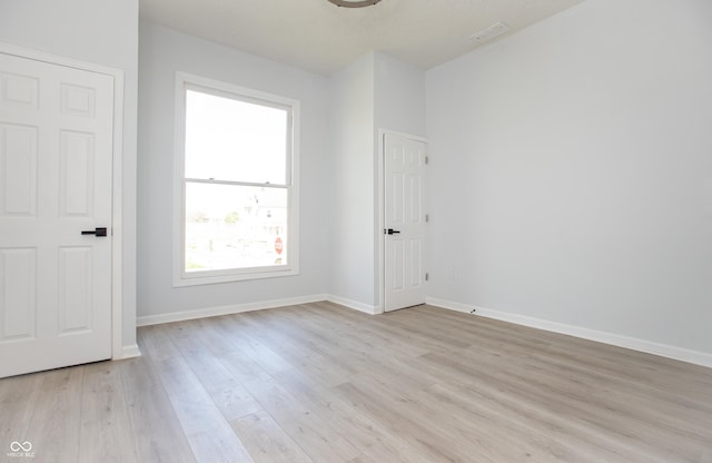 249 N Hamilton Ave, Indianapolis, IN 46201 - unfurnished room with baseboards, visible vents, and light wood finished floors