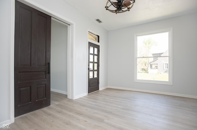 249 N Hamilton Ave, Indianapolis, IN 46201 - entrance foyer with light wood-style floors, baseboards, plenty of natural light, and visible vents