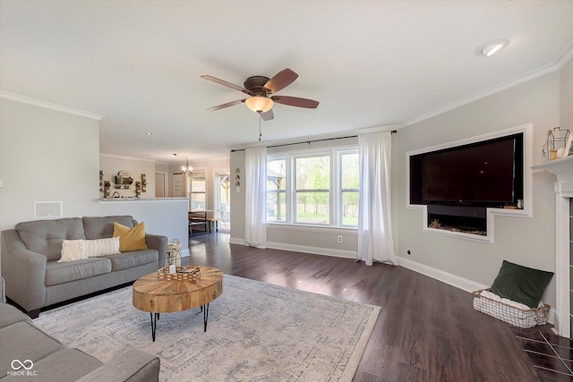 9011 Harrison Run Dr, Indianapolis, IN 46256 - living area featuring wood finished floors, baseboards, ceiling fan, ornamental molding, and a chandelier