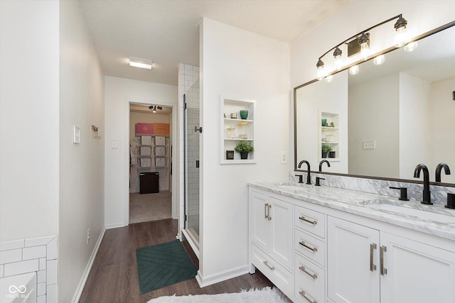 9011 Harrison Run Dr, Indianapolis, IN 46256 - full bathroom featuring double vanity, wood finished floors, a shower stall, and baseboards