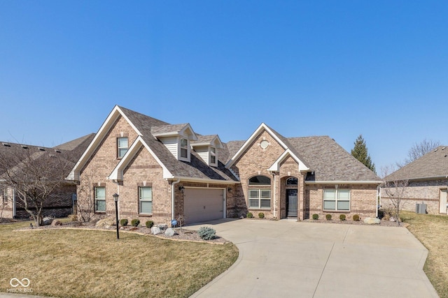 3792 Waterfront Way, Plainfield, IN 46168 - view of front of property featuring roof with shingles, concrete driveway, a front lawn, a garage, and brick siding