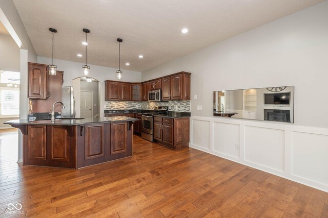 3792 Waterfront Way, Plainfield, IN 46168 - kitchen featuring stainless steel appliances, dark countertops, a peninsula, and dark wood finished floors