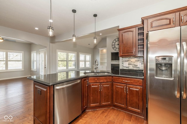 3792 Waterfront Way, Plainfield, IN 46168 - kitchen with open floor plan, appliances with stainless steel finishes, a peninsula, light wood-style floors, and a sink